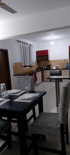 a dining room with a table and chairs and a kitchen at Chelsi Homes in Shanzu