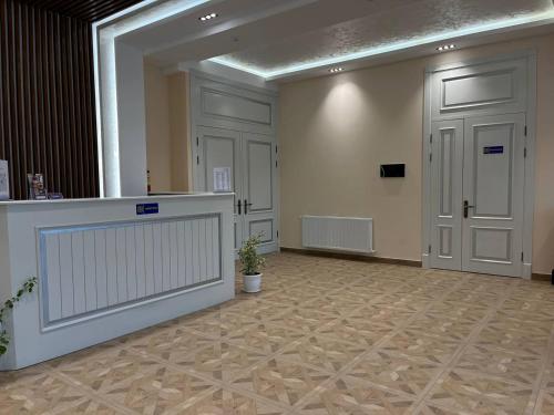 a large room with a counter and two doors at AKS Hotel in Tashkent