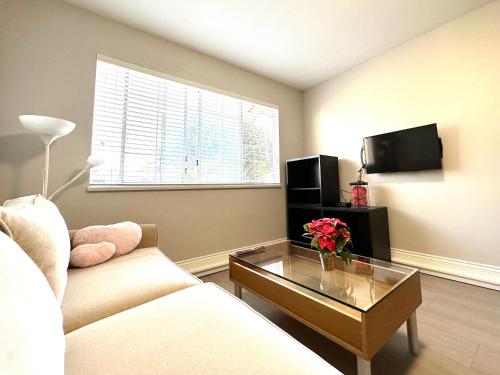 a living room with a couch and a coffee table at Newly renovated 2 bed 1 bath in Ladner BC in Delta