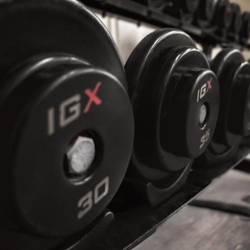 a row of black dumbbells in a gym at RIHGA Royal Laguna Guam Resort in Tamuning