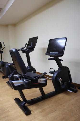a room with several exercise bikes and a computer monitor at RIHGA Royal Laguna Guam Resort in Tamuning