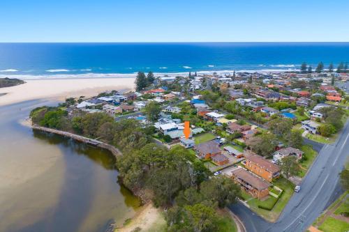 an aerial view of a town next to the beach at Aqua Cottage in Lake Cathie
