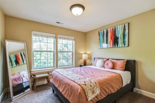 a bedroom with a large bed and a mirror at Spacious, Quiet, private, 5 BR Near Portland DT in Beaverton