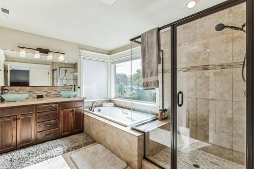 a bathroom with a tub and a glass shower at Spacious, Quiet, private, 5 BR Near Portland DT in Beaverton