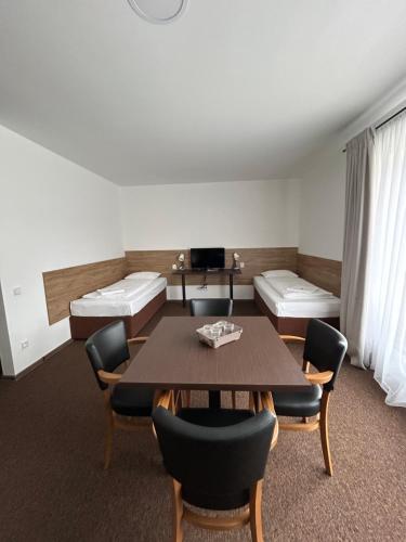 a room with a table and chairs and a couch at Motel R10 in Mladá Boleslav