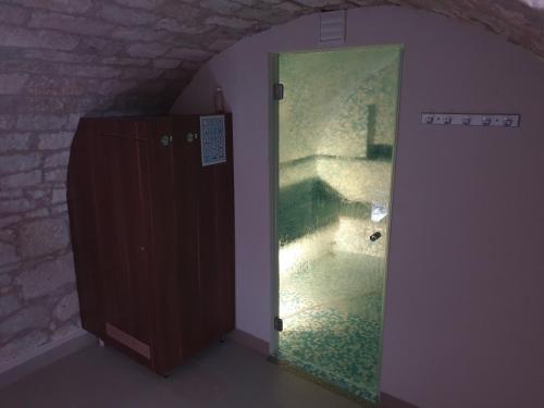 a room with a mirror and a door in a room at Aranydukát Vendégház Tállya in Tállya
