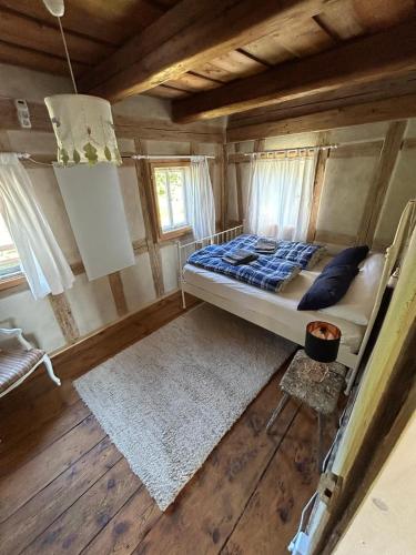 a bedroom with a bed in a log cabin at Mandauhaus Großschönau in Großschönau