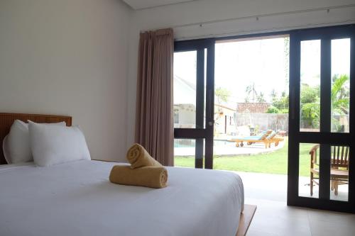 Postel nebo postele na pokoji v ubytování Dipenida Bali