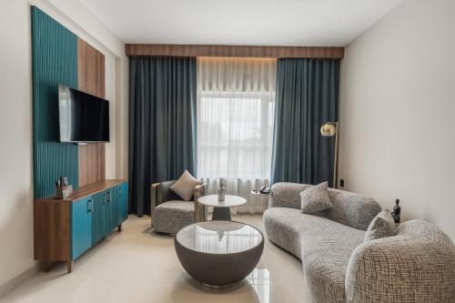 a living room with a couch and a table and a tv at VSC Porto Marina in Bālarāmpuram