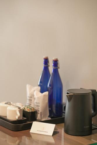 a tray with three blue bottles on a table at VSC Porto Marina in Bālarāmpuram