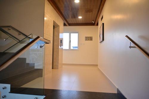 an empty hallway with a glass staircase in a building at Poorva Residency in Hassan