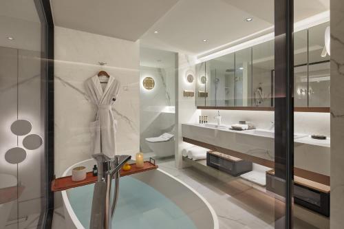a bathroom with a robe hanging on a wall at ISEYA Serviced Apart-ment Chengdu Taikoo Li Flagship in Chengdu
