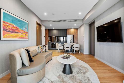 a living room with a couch and a table at Forbes Manaa Living in Perth