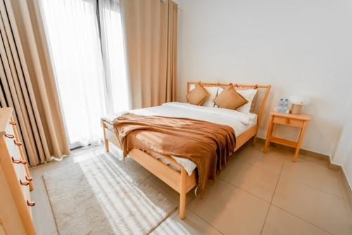 a bed in a room with a large window at Seascape Villa in Fujairah