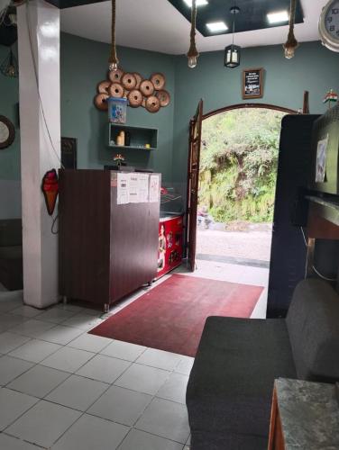 a kitchen with an open door to a room at Icebergs Mussoorie - A Boutique stay and 24 hrs roof top cafe in Mussoorie