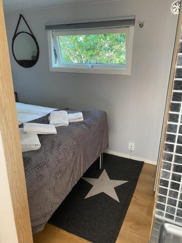 a bedroom with a bed and a window at Studio 51 Örgryte in Gothenburg