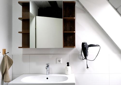 a white bathroom with a sink and a mirror at CASA LUXE - 80qm - Stadtmitte - Familienfreundlich - Parkplatz - 5km zum Legoland in Günzburg