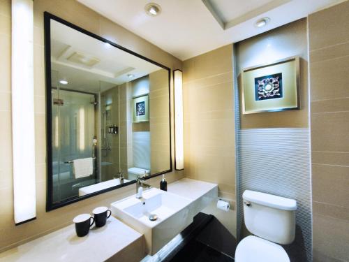 a bathroom with a toilet and a sink and a mirror at SSAW Boutique Hotel Hangzhou East - Free Self Service Laundry in Hangzhou