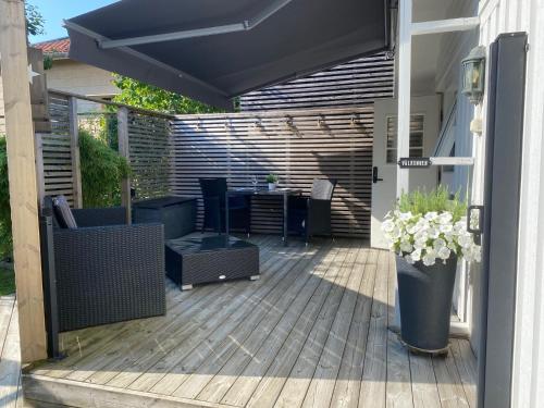 a patio with an umbrella and a table and chairs at Studio 51 Örgryte in Gothenburg