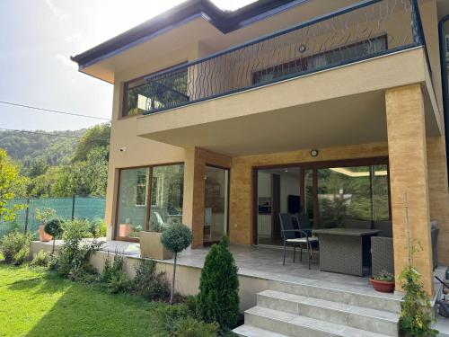 a house with a balcony with a view at Villa Rivus in Sarajevo