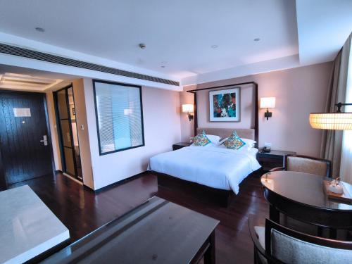 a hotel room with a bed and a dining room at SSAW Boutique Hotel Hangzhou East - Free Self Service Laundry in Hangzhou