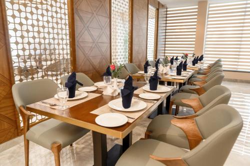 a row of tables and chairs in a restaurant at VSC Porto Marina in Bālarāmpuram