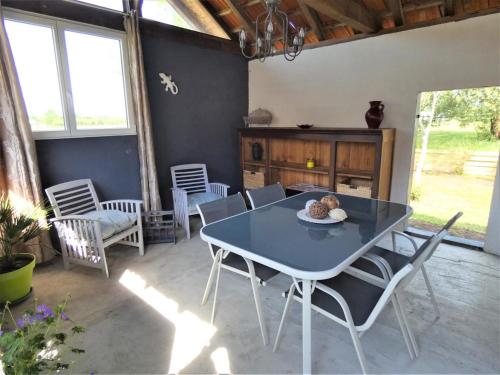 une salle à manger avec une table et des chaises bleues dans l'établissement Le gite d'antoine, à Saint-Julien-en-Born