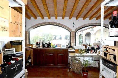 a kitchen with a large window and a counter with wine bottles at Locanda Stella d'Oro in Soragna