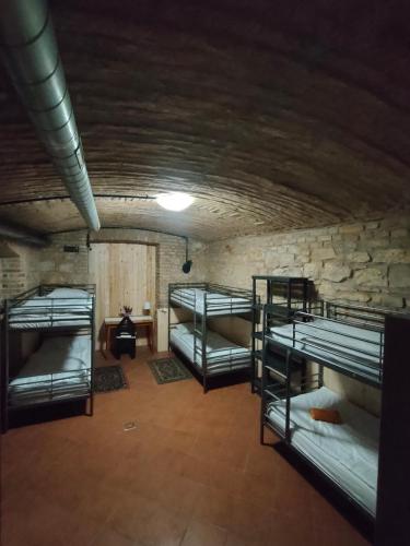 a room with four bunk beds in a cave at Alba Hostel in Prague