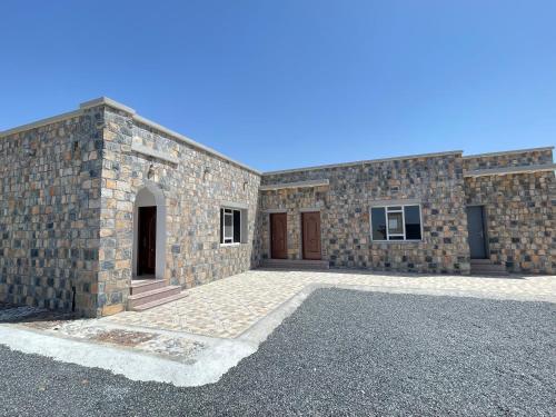 a large brick building with two doors on it at Jabal Shams, the summit house in Misfāh