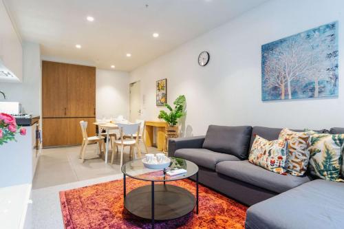 a living room with a couch and a table at Lucia South Yarra Pool Gym free Parking in Melbourne