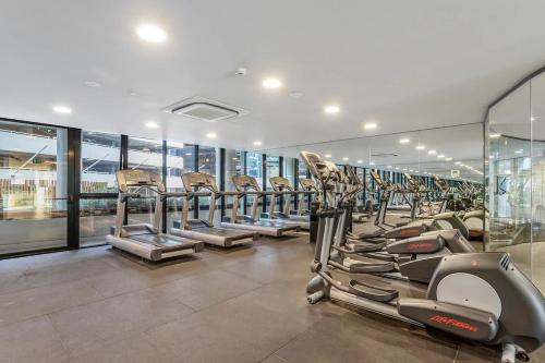 a gym with a row of treadms and elliptical machines at Lucia South Yarra Pool Gym free Parking in Melbourne