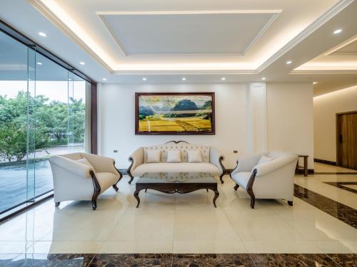 a living room with a couch and two chairs at Nui Vang Trang An Hotel Ninh Binh in Ninh Binh