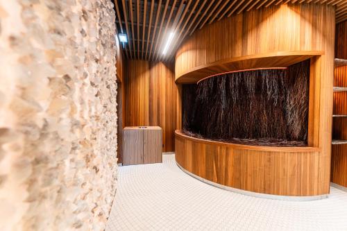a large wooden room with a large stage at Instytut Zdrowia Sofra FIT & SPA in Mielno