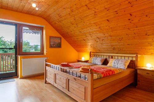 a bedroom with a large bed in a wooden house at Ferienwohnung Schank in Sauldorf