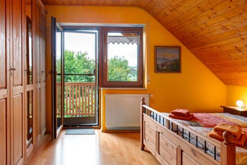 a bedroom with a bed and a large window at Ferienwohnung Schank in Sauldorf