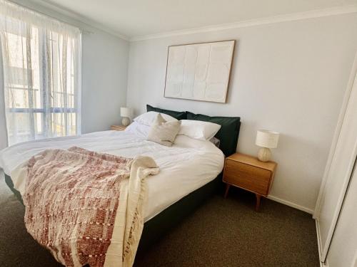 a bedroom with a bed and a window at Central City Apartment 'The Olive' in Christchurch