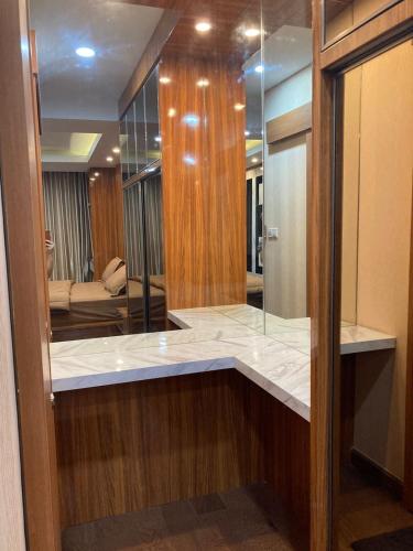 a bathroom with a marble counter with a mirror at Casapedian 010 Vasaka Reiz Condo 1 BR in Medan