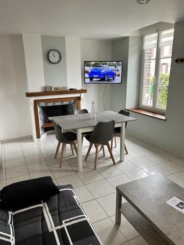 a living room with a table and a tv at Appartement 29A - MAILLY LE CAMP in Mailly-le-Camp