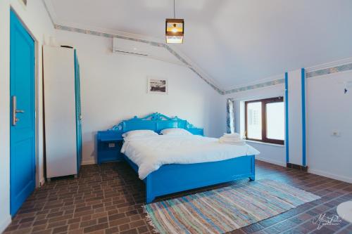 a bedroom with a blue bed in a room at La Navod Jurilovca in Jurilovca