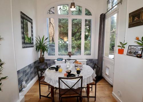 une salle à manger avec une table et une fenêtre dans l'établissement 2eme étage privé de notre maison-Accès au jardin-Smart tv-Streaming-Wifi, au Mans