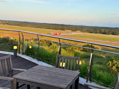 a table and chairs on a balcony with a view of a train at 24'HR CHECK IN H'FLOOR SARADISE MERRITON RESIDENCY KUCHING LUXURY BALCONY FACING AIRPORT 3R2B-2Cpark in Kuching