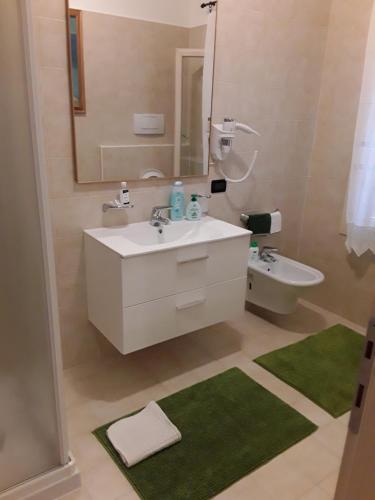 a bathroom with a sink and a mirror and a toilet at Locanda Bellavista in Cavaso del Tomba