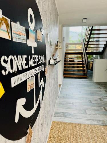 a hallway with a wall with some meet sign on it at Pension Ostsee-Strand in Börgerende-Rethwisch