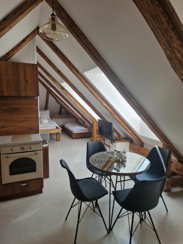 a room with a table and chairs in a attic at Apartmán v Podkroví in Kremnica
