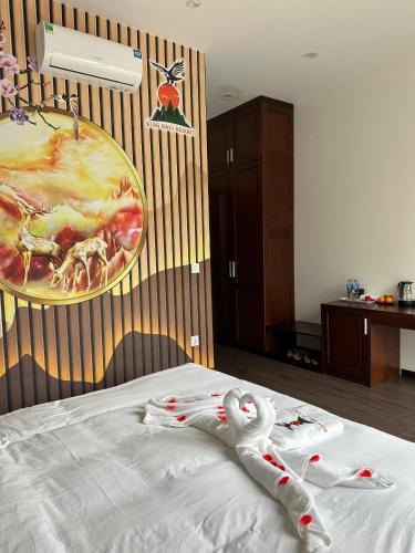 a white swan is laying on a bed at King Bavi Resort in Ba Vì