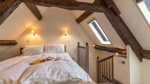 a bedroom with a bed with fruit on it at Spinner's Cottage in Burford