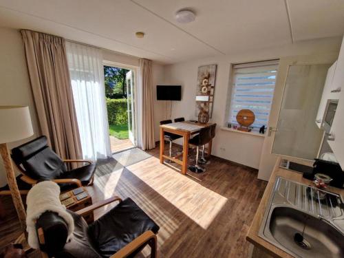 a living room with a couch and a table and a desk at Bed & Breakfast Inn Drenthe in Fluitenberg