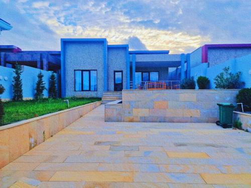 a blue building with a staircase in front of it at Mardakan Villa in Baku