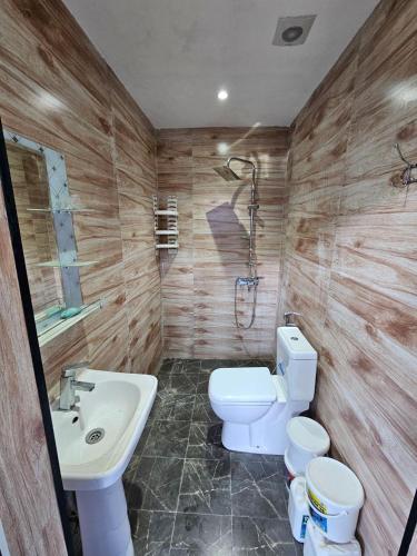 a bathroom with a toilet and a sink at Mardakan Villa in Baku